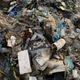 A Coca-Cola bottle sits on a garbage-filled beach on the Freedom Island critical habitat and ecotourism area near Manila in the Philippines.